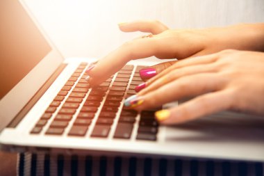 close up photo of woman hand typing on laptop
