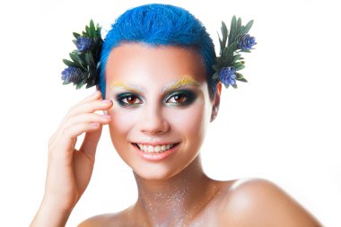 Elegant young girl with multicolor makeup smiling on camera