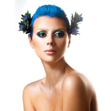 Cutie young girl with multicolor makeup andflowers in hair looki