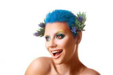 Funny girl with multicolor makeup smiling on white background