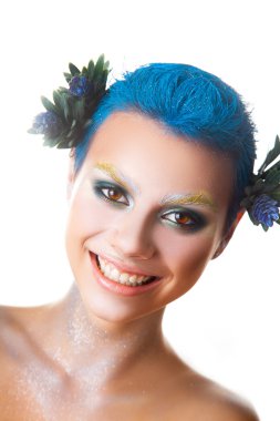 Fun girl with multicolor makeup and short blue hairstyle smiling