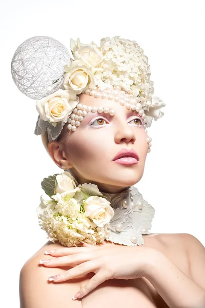 Pretty young girl with tender makeup and flowers on white backgr — Stock Photo, Image