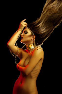 High creative hairstyle on sexual young woman with golden access
