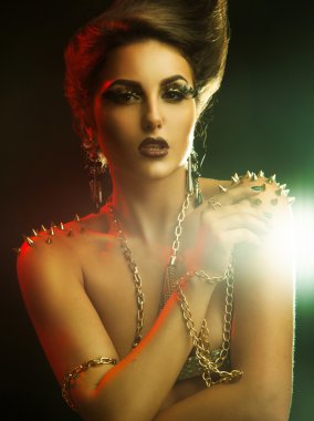 Vertical photo of beautiful young woman with golden accessories