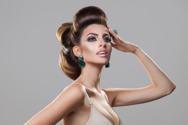 Adorable young girl looking away on grey background. Professiona