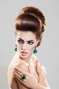 Portrait on grey background of young girl with creative hairstyl