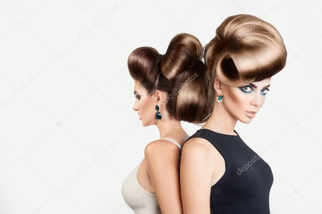 Two beautiful women in studio. Both with creative hairstyle and