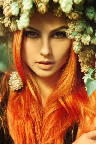 Cutie young redhair lady looking at camera with hop on head — Stock Photo, Image