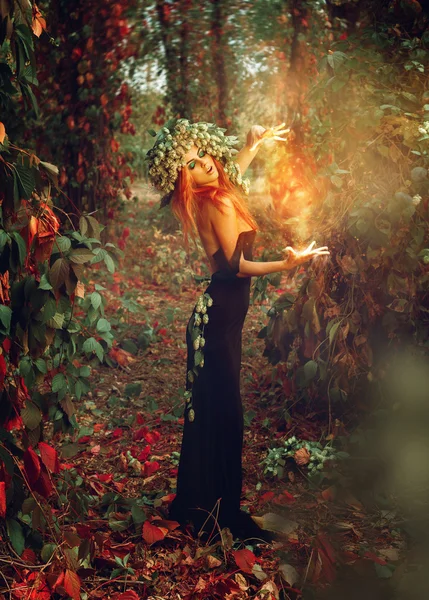 Vertical photo of terrific redhead witch conjures in the woods — Stock Photo, Image