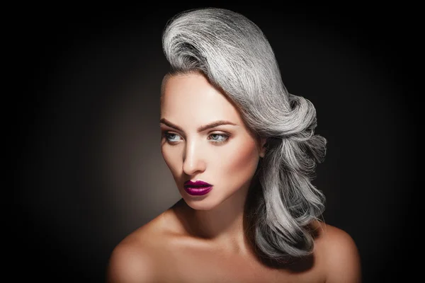 Young woman with grey hair color and beautiful makeup in studio — Stock Photo, Image