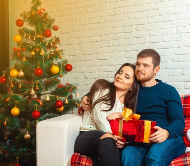 Square christmas portrait of young couple in love