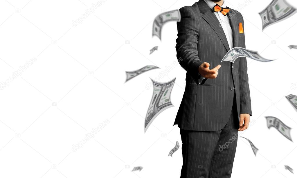 businessman in a suit throws a lot of money isolated on white ba