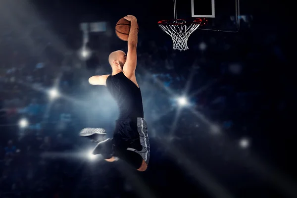 Basketball player jumping to the ring and makes slam dunk — Stock Photo, Image