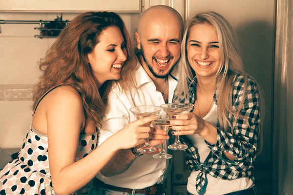 Couple of beautiful ladies having fun with a guy at a party with — Stock fotografie