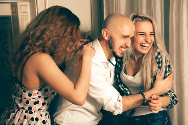 Three fashionable friends at house party laughing — Stockfoto