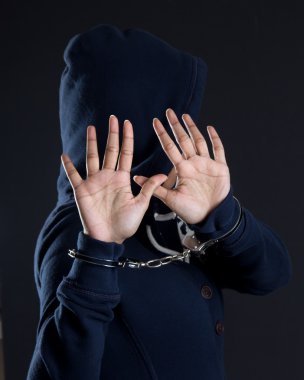 Women in handcuffs avoiding being photographed clipart