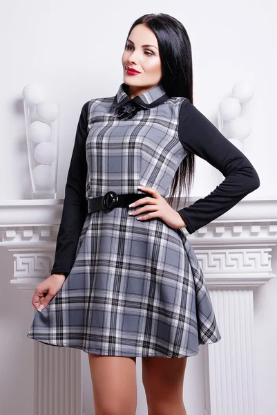 Brunette woman in stylish checkered dress — Stock Photo, Image