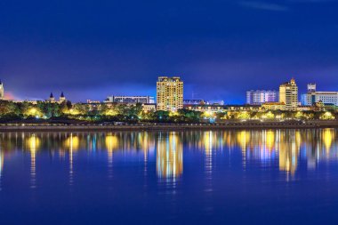 Blagoveshchensk, Rusya - 25 Haziran 2020: Blagoveshchensk şehrinin setinden Çin 'in Heihe şehrine bakış. Gecenin ışıkları Amur nehrinin yansımasında..