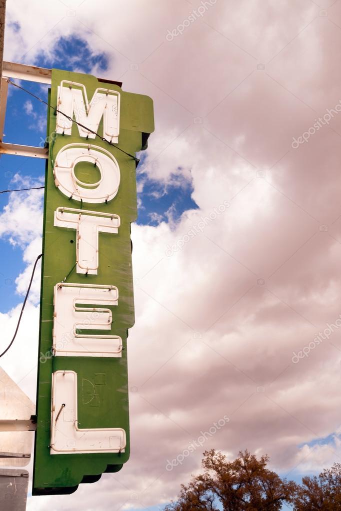 Neon Motel Sign Clear Blue Sky White Billowing Clouds