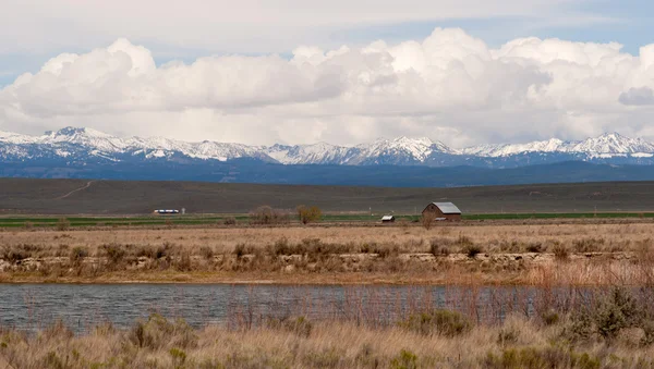 木製の納屋 Wallowa 山ふくらんでいる雲劇的なオレゴン州のスカイライン — ストック写真