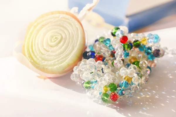 Onion and beads — Stock Photo, Image