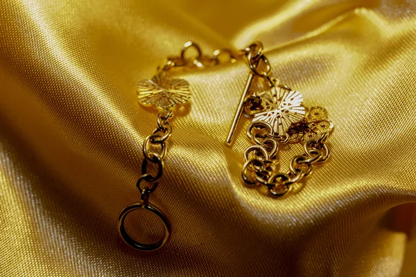 Gold bracelet on a gold background — Stock Photo, Image