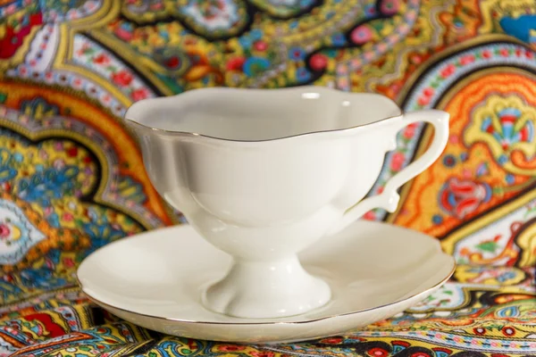 Prcelain cup with saucer in multi colours — Stock Photo, Image