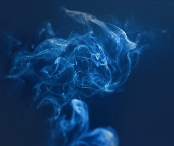 Beauty abstraction with smoke in dark and blue colours