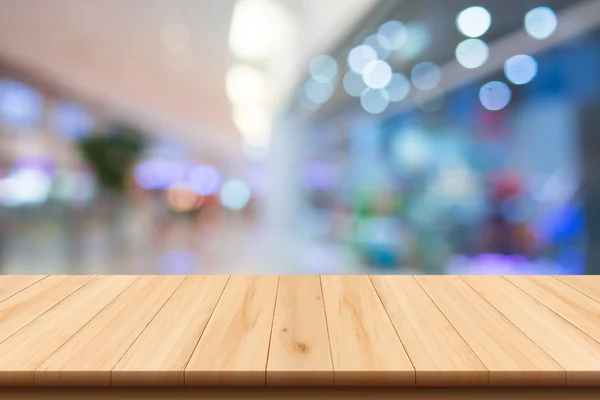 Centro comercial fondo borroso con bokeh y suelo de madera — Foto de Stock