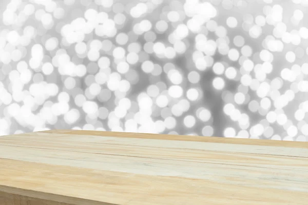 Wood table in front of white bright bokeh lights — Stock Photo, Image