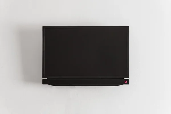 Black LCD or LED tv screen hanging on a wall — Stock Photo, Image