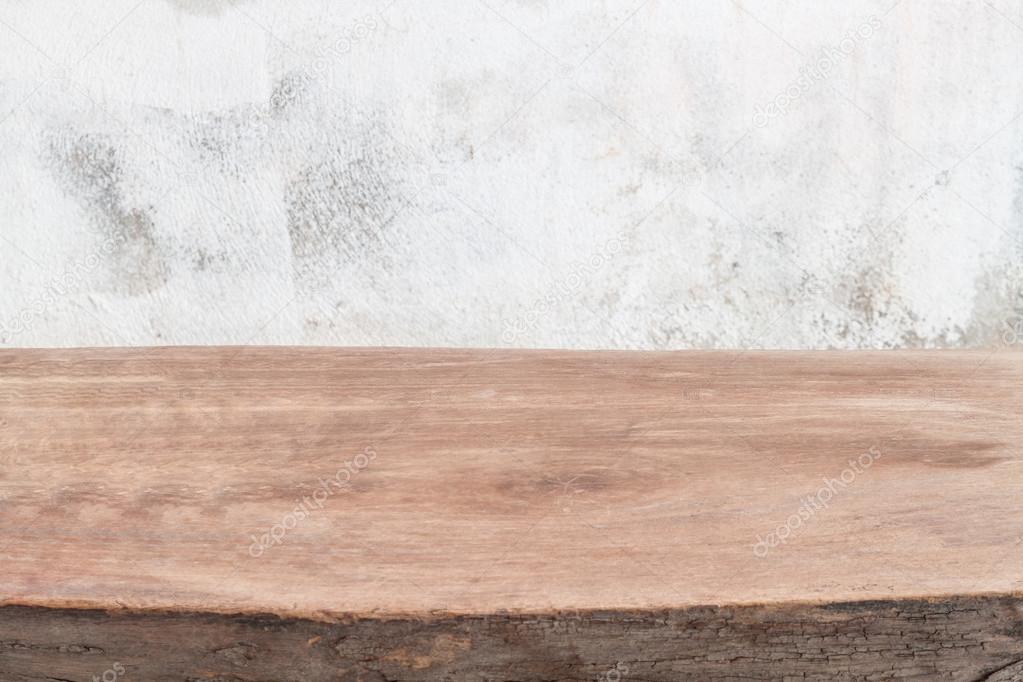 Empty wooden table over grunge wall