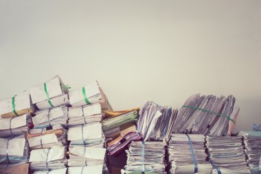 Stack of business report paper files on the document racks