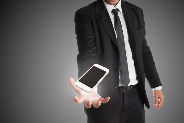 Smart phone in hand with businessman — Stock Photo, Image