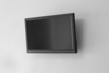 Black LCD or LED tv screen hanging on a wall background clipart