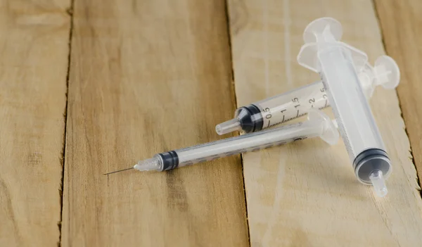 Syringe on wooden — Stock Photo, Image