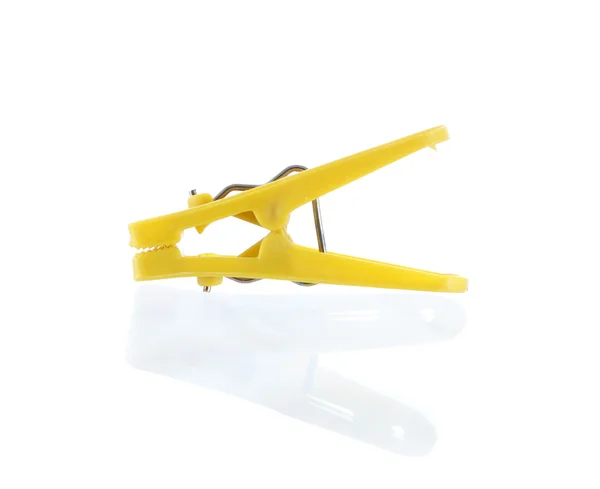 Yellow plastic cloth peg and reflection — Stock Photo, Image