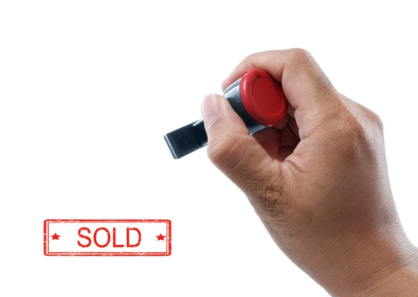 Hand houden verkocht rubber stempel — Stockfoto
