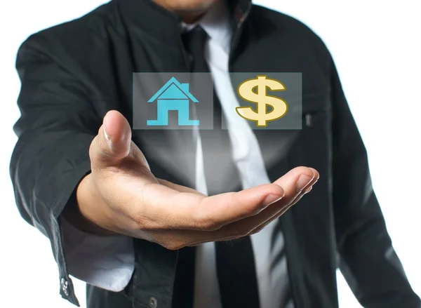 Businessman holding house and money icon — Stock Photo, Image