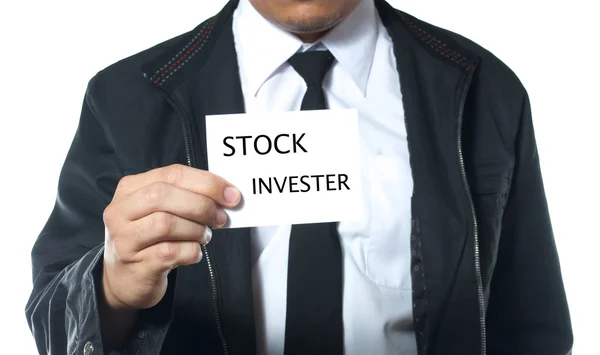 Hand som håller kort stock investeraren Stockfoto