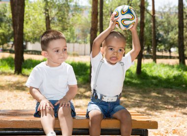 Little boys with soccer ball in park clipart