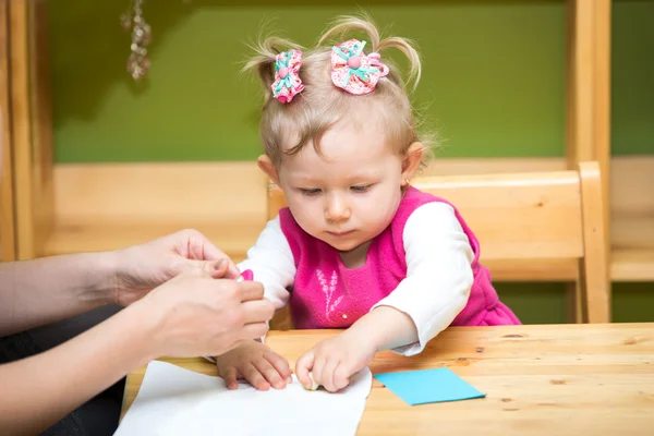 Mother and child girl playing in kindergarten — Stock Photo, Image