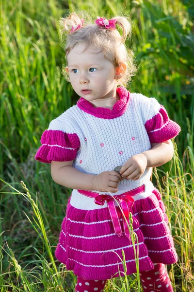 Little child girl on grass on meadow. — Stock Photo, Image