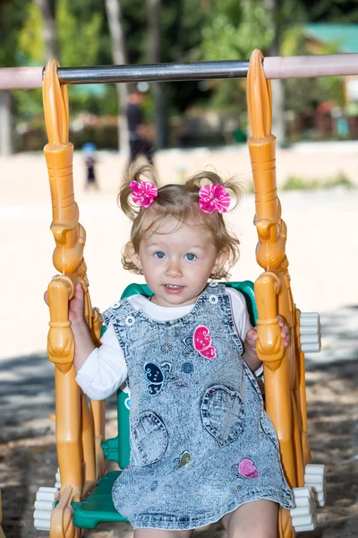 Enfant fille sur swing sur aire de jeux — Photo