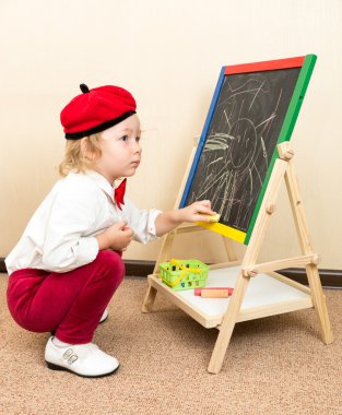 Girl drawing with chalks clipart