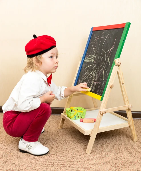 Girl drawing with chalks Royalty Free Stock Images