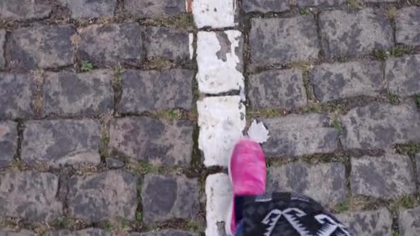 POV feet stepping by road marking line at cobblestone pavement — Stock Footage POV feet stepping by road marking line at cobblestone pavement Stock Footage