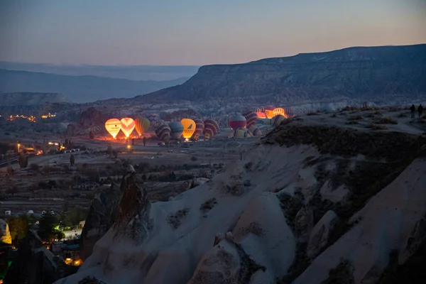 Colorful hot air balloons glowing in blue hour sunrise landscape of Cappadocia — Stock Photo, Image