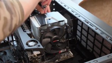 Tornavidalı adam elleri PC ana kartından NVidia GeForce grafik kartı takılı CPU soğutucusunu söker