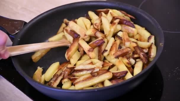 Fritar e mexer batatas fritas caseiras na panela no fogão de cozinha — Vídeo de Stock